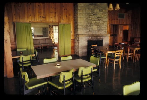 Shorewood Club Building, interior with green chairs and curtains Slide
