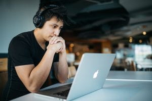 Image of person wearing headphones joining a web meeting on a laptop