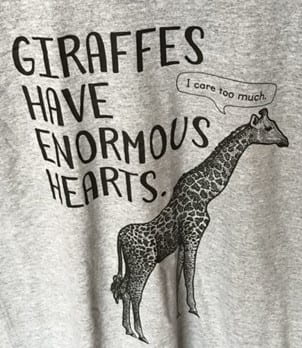 Illustration of a giraffe with text which reads "Giraffes have enormous hearts" and a speech bubble from the giraffe saying "I care too much."