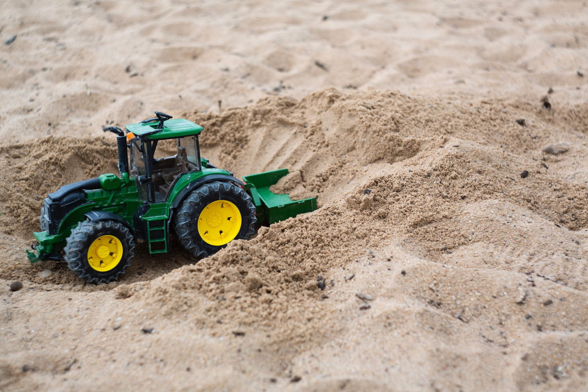 Decorative image of sandbox with a toy truck.