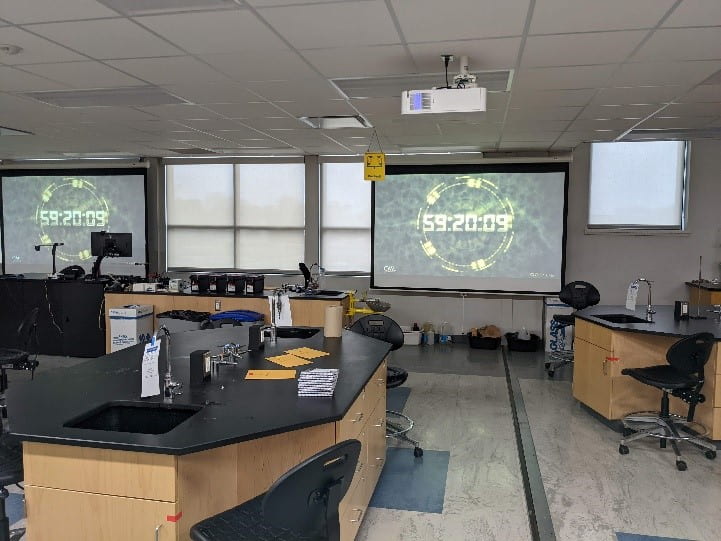 a chemistry classroom with a counting down timer on a projector screen