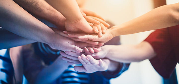 Group of peoples hands together for teambuilding