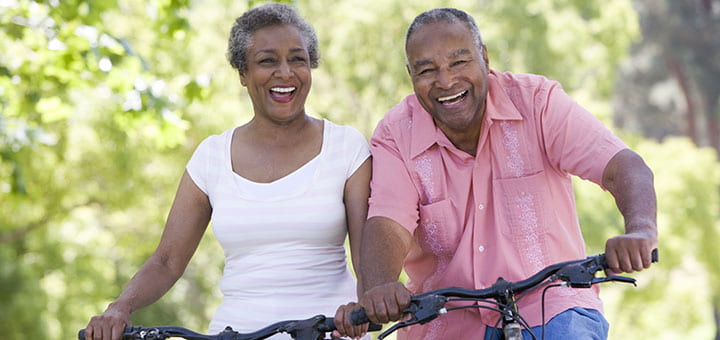 Happy older couple riding bicycles